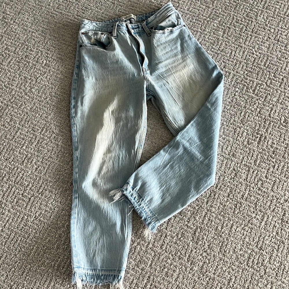 Light wash faded jeans with frayed hem